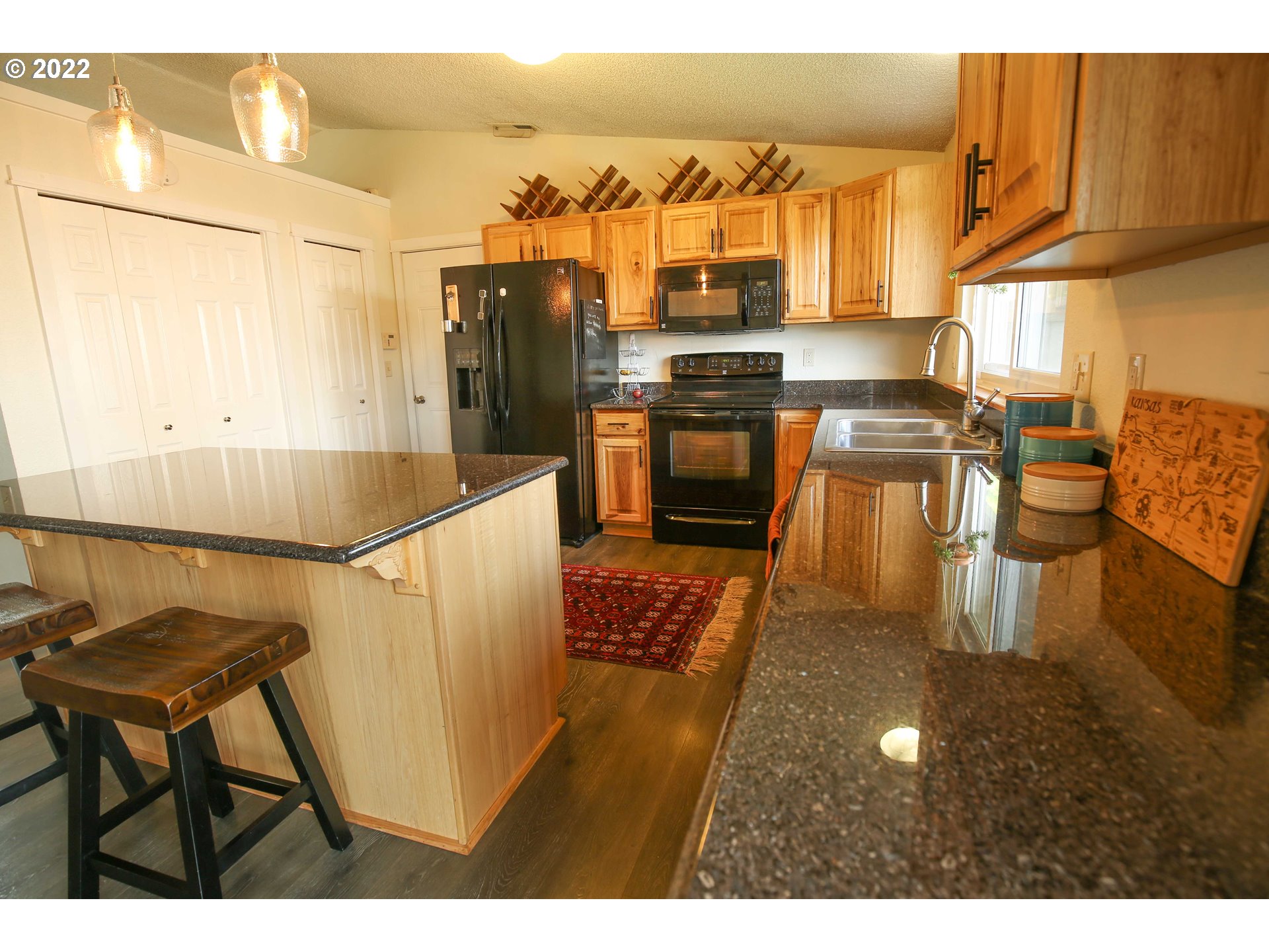 1071 Cole Way Springfield, OR 97478 - Photo 8 of 30 a living room with stainless steel appliances kitchen island granite countertop furniture and a kitchen view