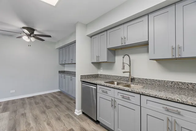 a kitchen with cabinets appliances a sink and a counter top space