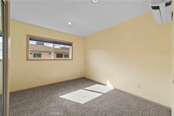 an empty room that has a glass door and shower