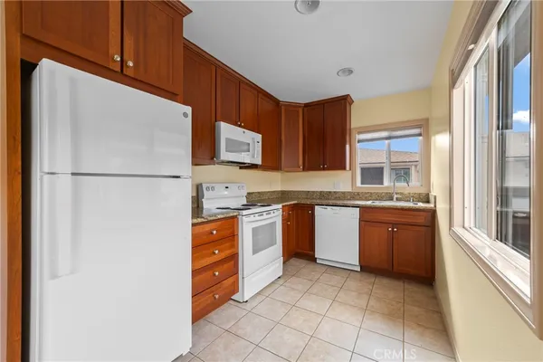 a bathroom with a granite countertop toilet and a shower