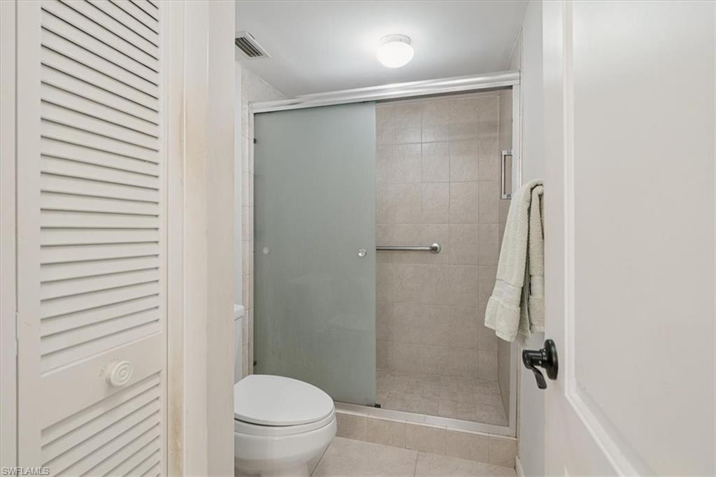 75 St Andrews Boulevard, Unit C301 Naples, FL 34113 - Photo 18 of 42 a bathroom with a shower and a toilet