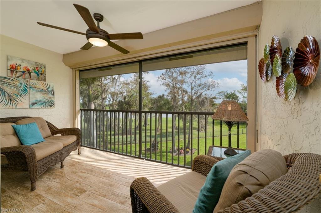 75 St Andrews Boulevard, Unit C301 Naples, FL 34113 - Photo 2 of 42 a living room with furniture and a large window