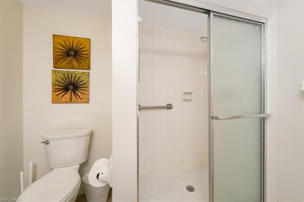 75 St Andrews Boulevard, Unit C301 Naples, FL 34113 - Photo 23 of 42 a bathroom with a toilet and a shower