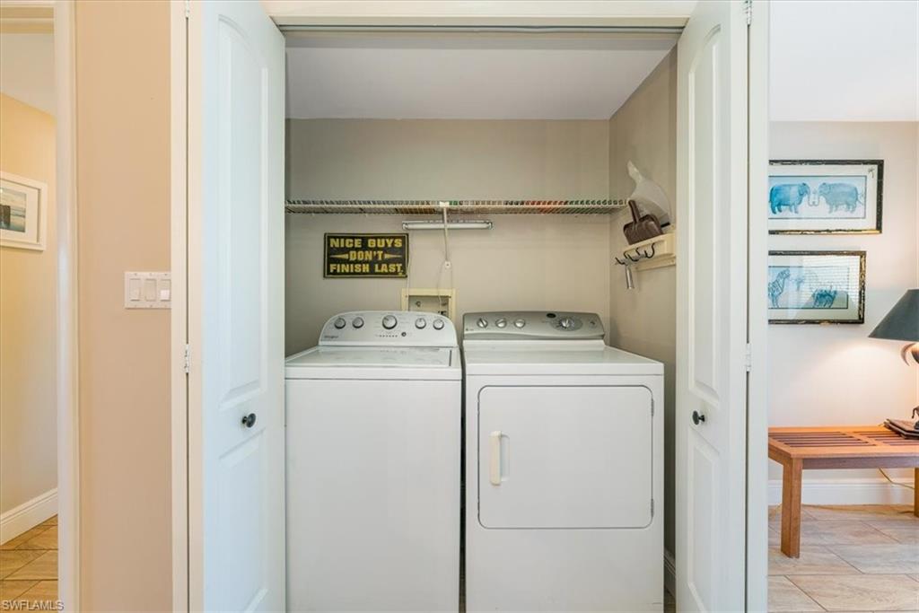75 St Andrews Boulevard, Unit C301 Naples, FL 34113 - Photo 24 of 42 a utility room with dryer and washer