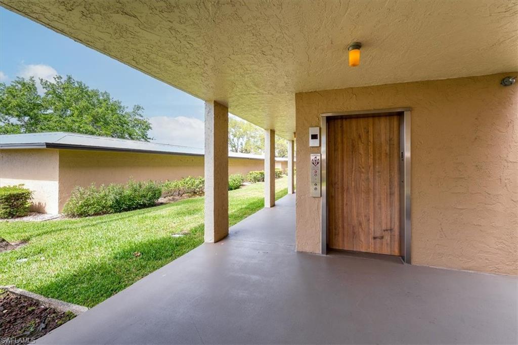 75 St Andrews Boulevard, Unit C301 Naples, FL 34113 - Photo 26 of 42 a view of a porch with a yard
