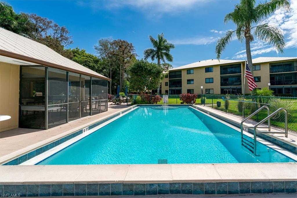 75 St Andrews Boulevard, Unit C301 Naples, FL 34113 - Photo 32 of 42 a swimming pool with outdoor seating and yard