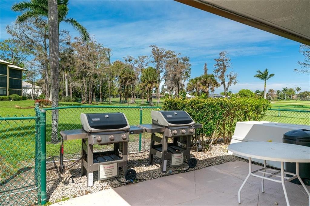 75 St Andrews Boulevard, Unit C301 Naples, FL 34113 - Photo 37 of 42 a view of a chairs and table in backyard of the house