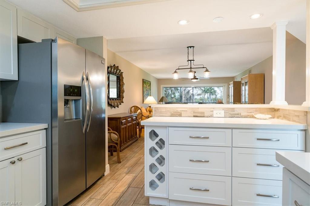 75 St Andrews Boulevard, Unit C301 Naples, FL 34113 - Photo 6 of 42 a bathroom with a double vanity sink and refrigerator