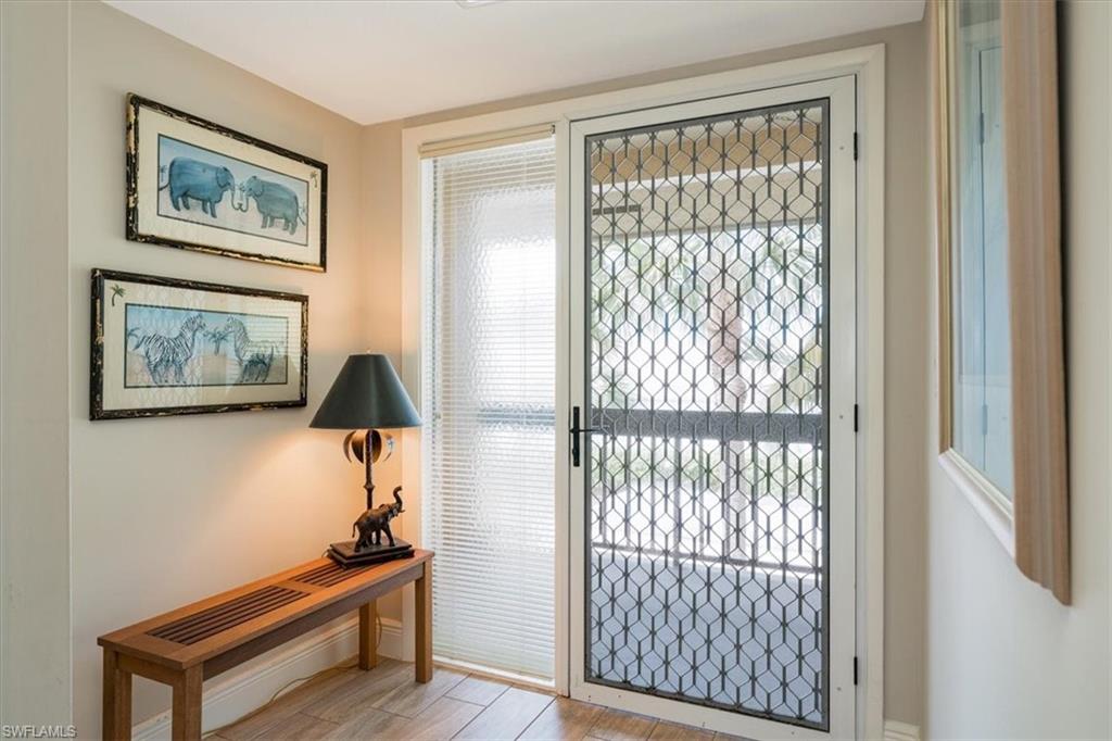 75 St Andrews Boulevard, Unit C301 Naples, FL 34113 - Photo 9 of 42 a living room with furniture and a window
