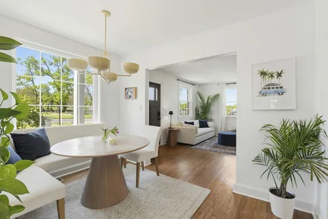 a view of a dining room with furniture window and wooden floor