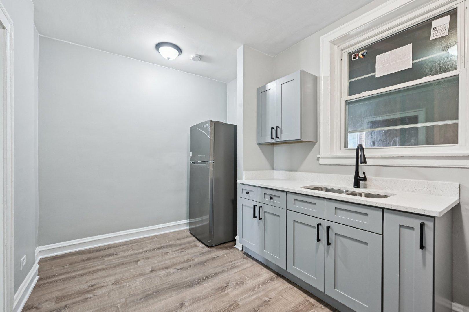 2506 East 78th Street, Unit 2 Chicago, IL 60649 - Photo 11 of 24 a kitchen with cabinets and stainless steel appliances