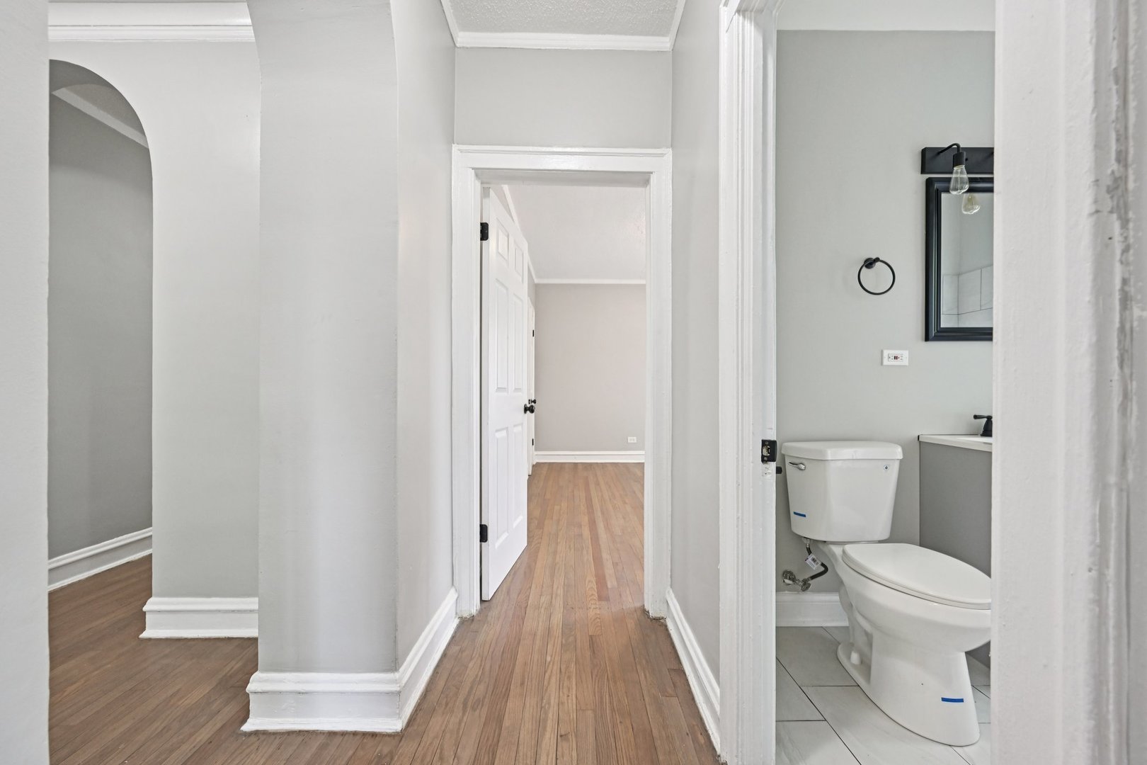 2506 East 78th Street, Unit 2 Chicago, IL 60649 - Photo 19 of 24 a bathroom with a toilet and a hardwood