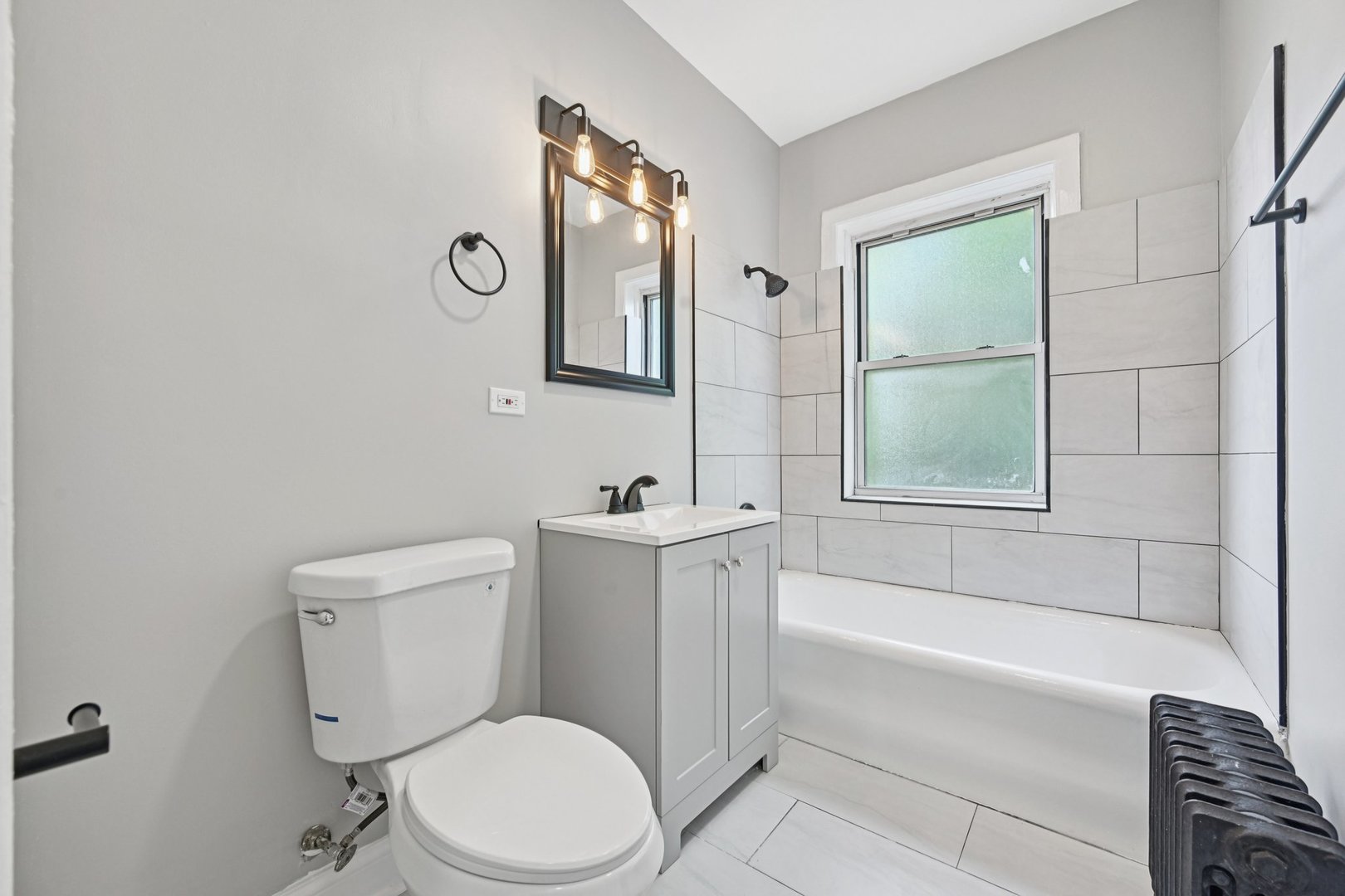 2506 East 78th Street, Unit 2 Chicago, IL 60649 - Photo 20 of 24 a bathroom with a toilet a sink and bathtub