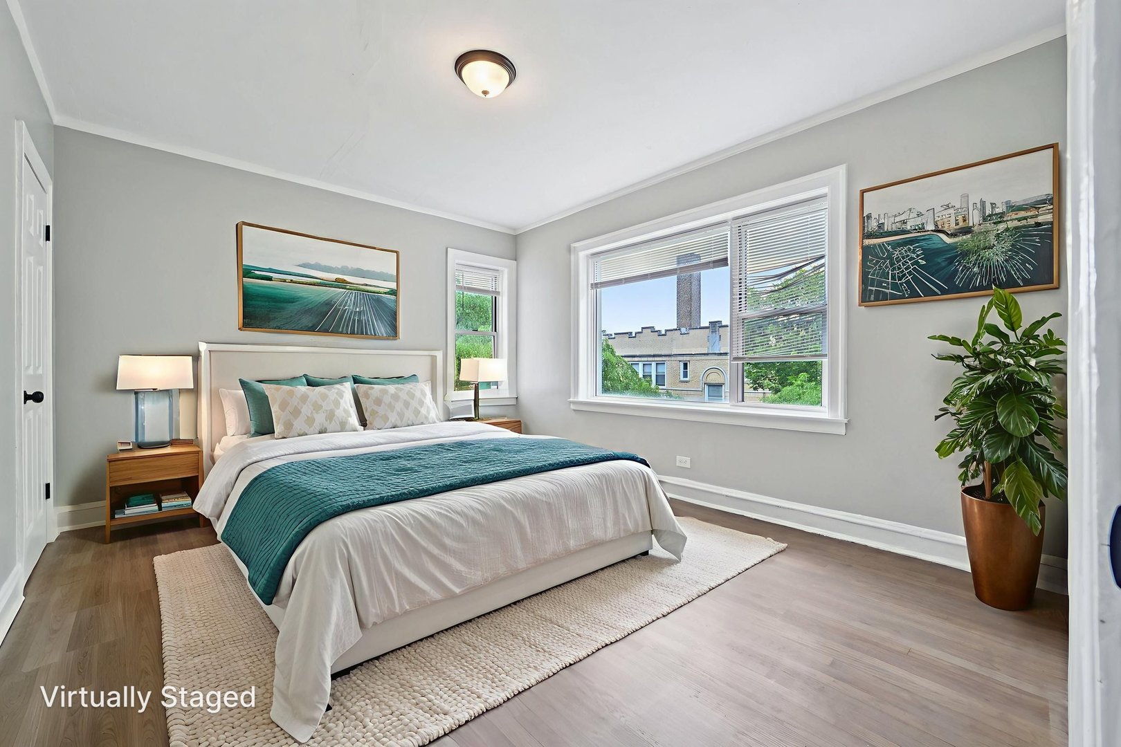 2506 East 78th Street, Unit 2 Chicago, IL 60649 - Photo 21 of 24 a bedroom with a large bed and a potted plant