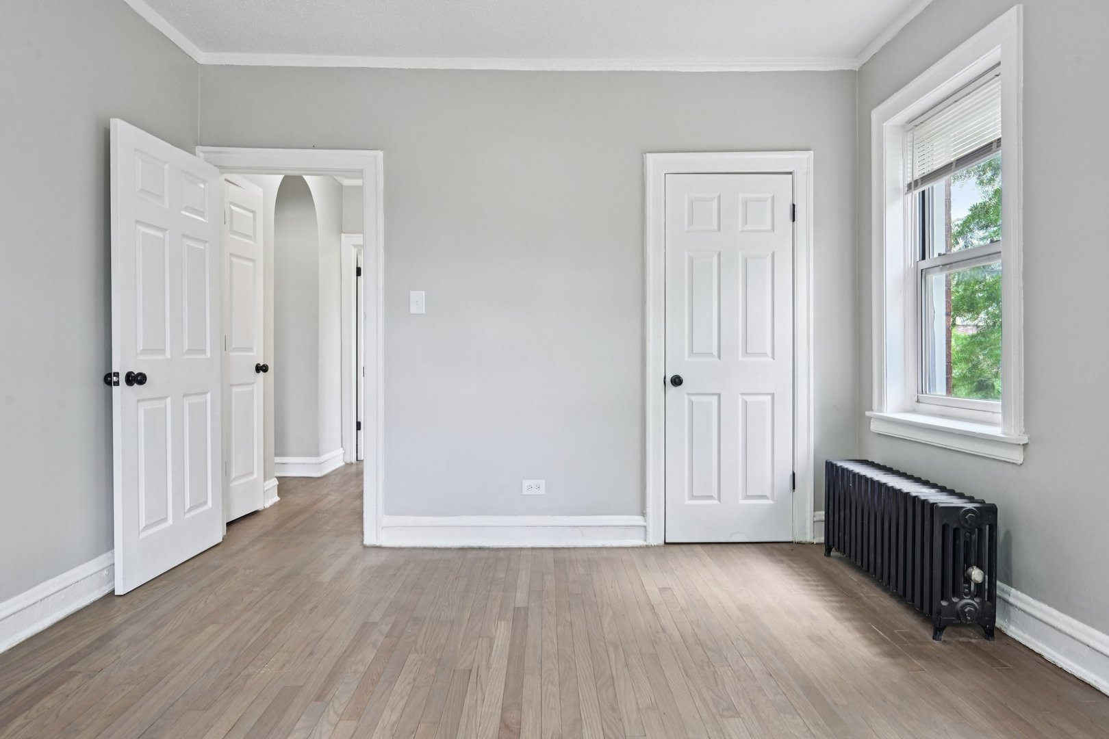 2506 East 78th Street, Unit 2 Chicago, IL 60649 - Photo 24 of 24 an empty room with wooden floor and windows