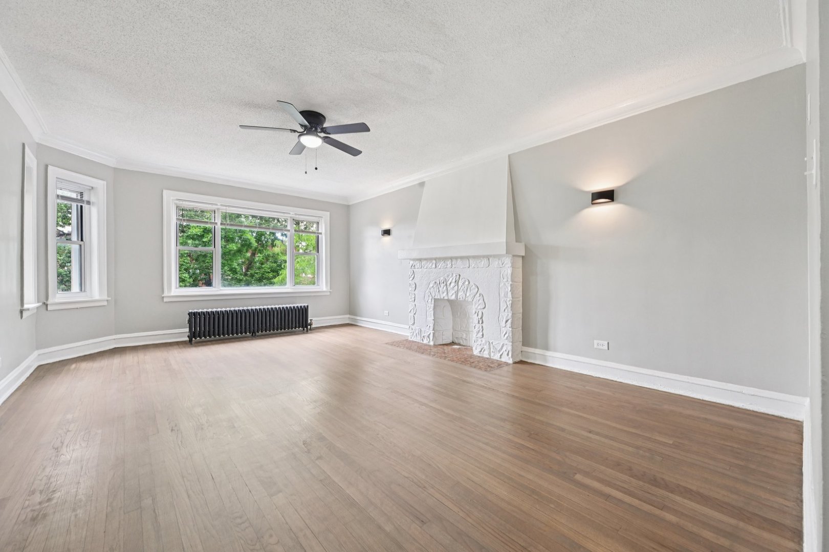 2506 East 78th Street, Unit 2 Chicago, IL 60649 - Photo 4 of 24 a view of empty room with wooden floor and fan