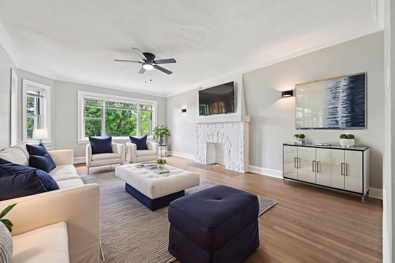 2506 East 78th Street, Unit 2 Chicago, IL 60649 - Photo 5 of 24 a living room with furniture a fireplace and a flat screen tv