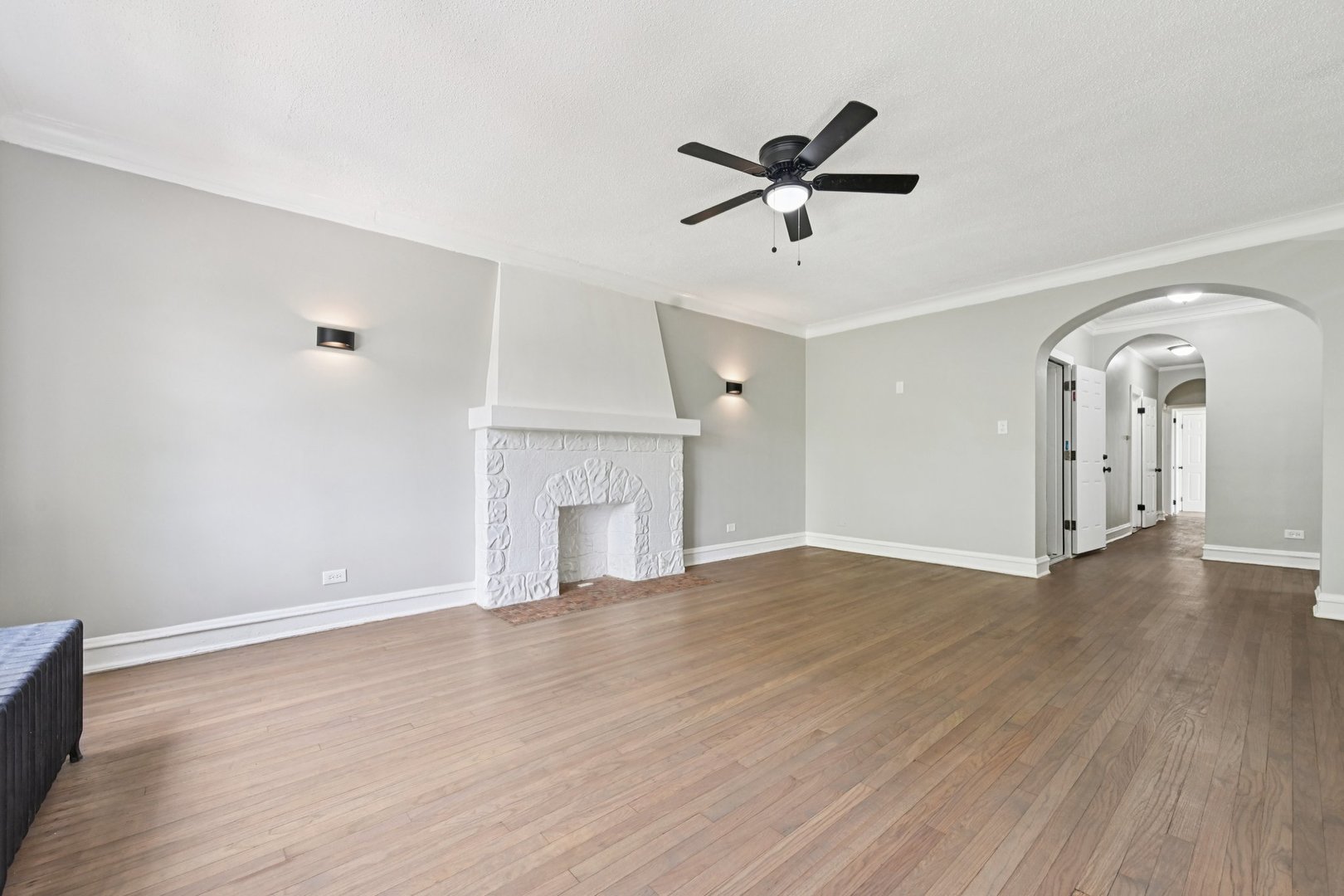 2506 East 78th Street, Unit 2 Chicago, IL 60649 - Photo 6 of 24 a view of empty room with wooden floor and fireplace