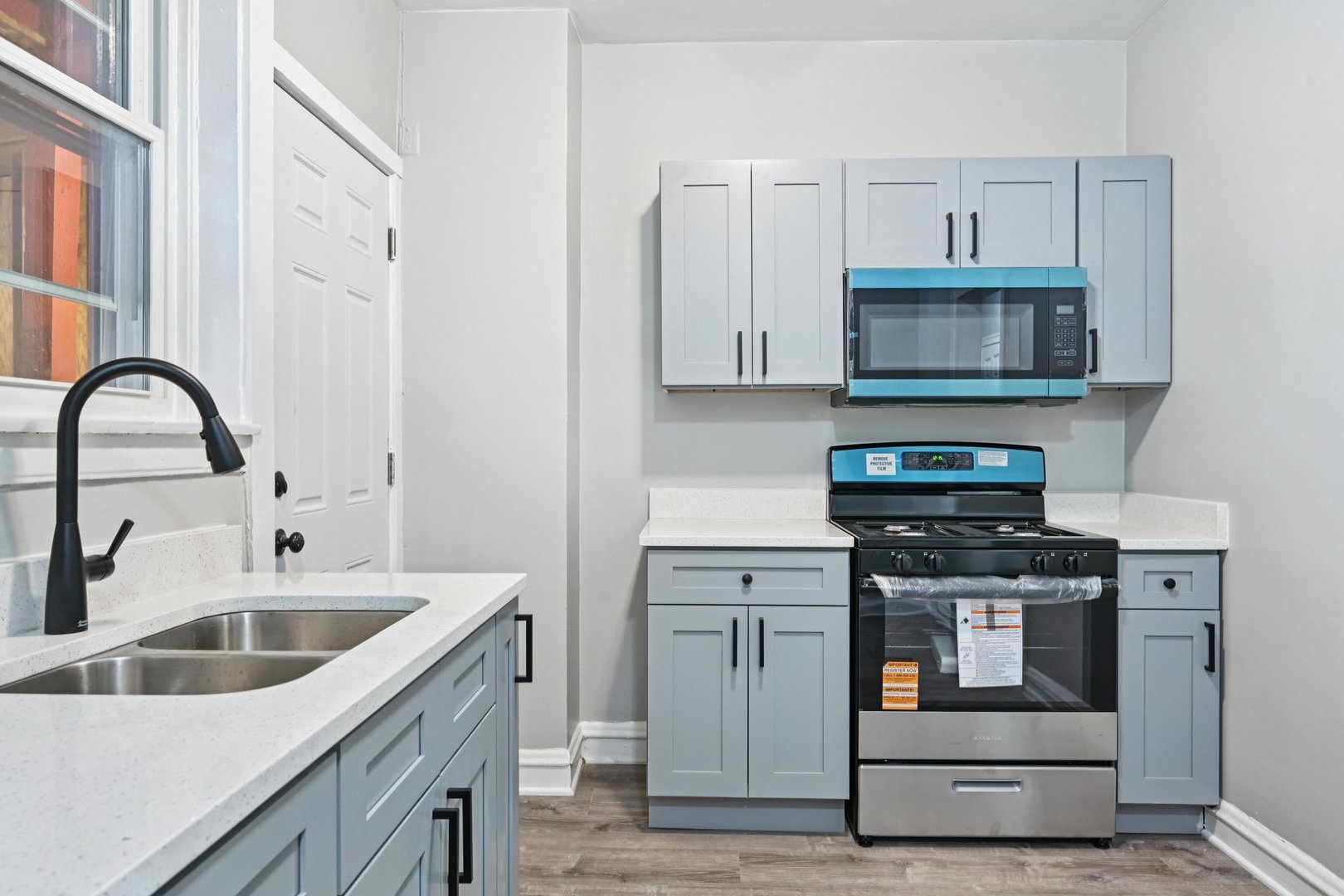 2506 East 78th Street, Unit 2 Chicago, IL 60649 - Photo 10 of 24 a kitchen with stainless steel appliances granite countertop a stove a sink and a microwave