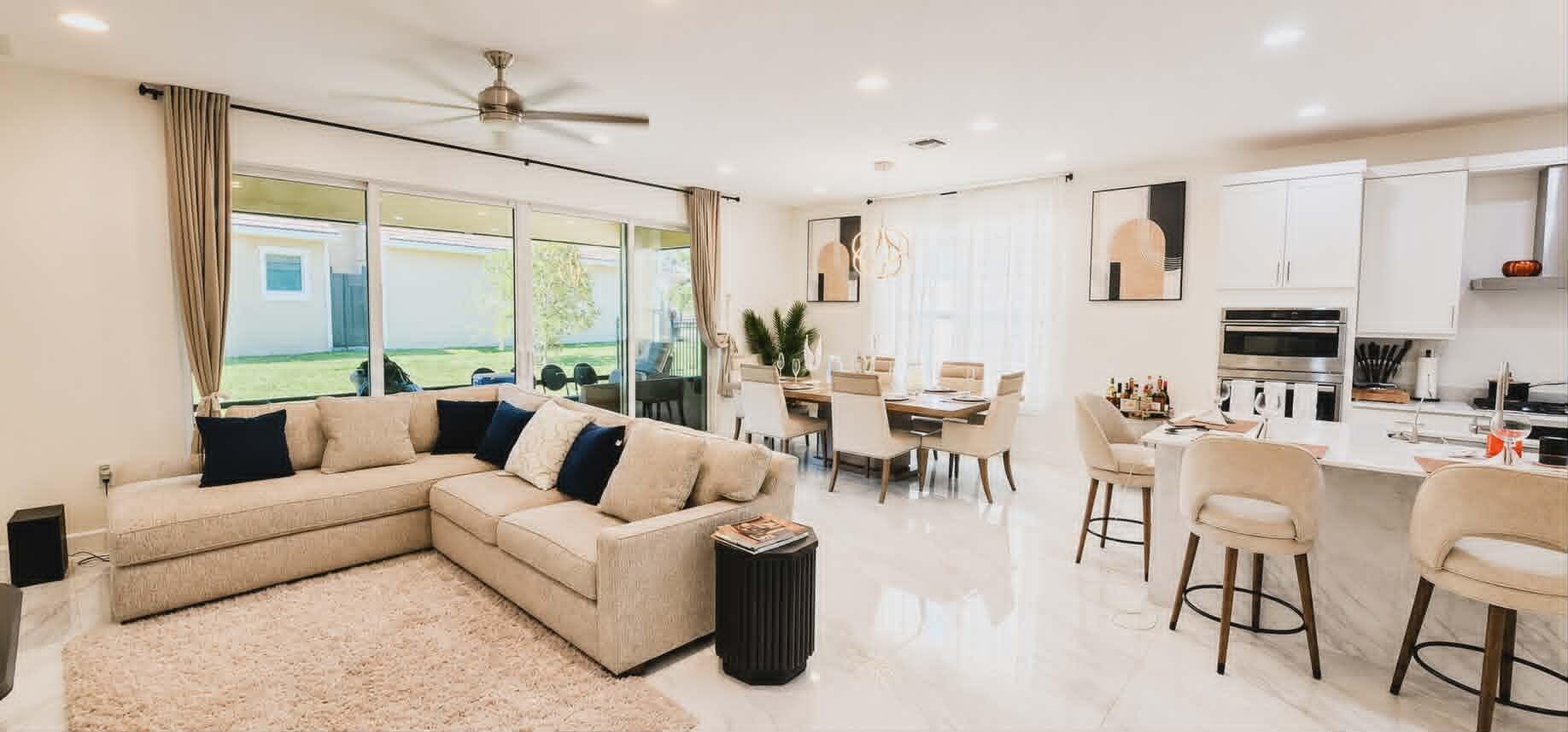 19179 Rolling Acrs Road Loxahatchee, FL 33470 - Photo 18 of 38 a living room with furniture kitchen view and a large window