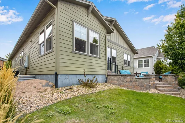 a view of a house with backyard and sitting area