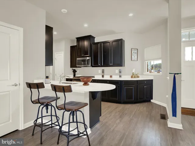 a spacious bathroom with a granite countertop sink and a mirror