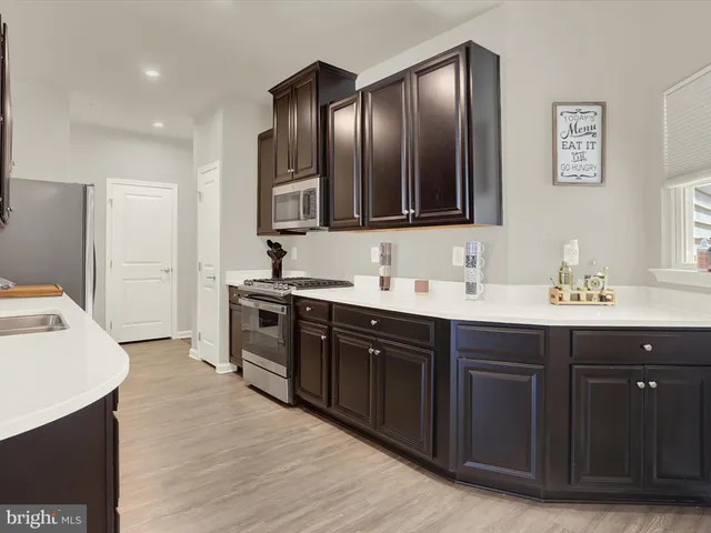 a kitchen with a sink and stainless steel appliances