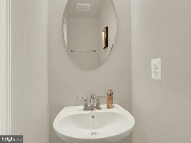 a living room with furniture a flat screen tv and kitchen view