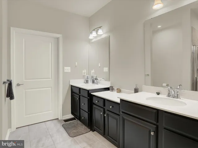 a bathroom with a sink vanity mirror and toilet
