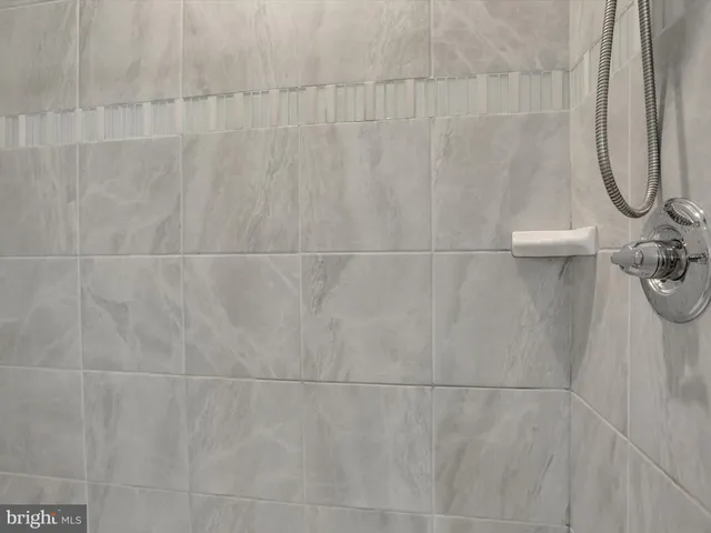 a bathroom with a sink a toilet a shower and a mirror