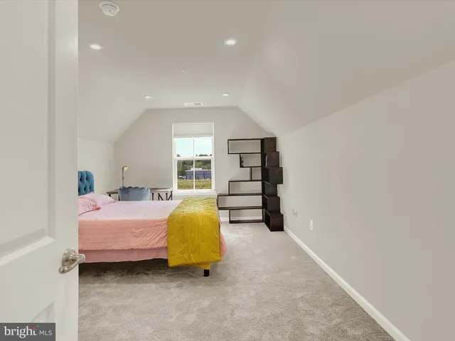 a spacious bedroom with a bed and a walk in closet