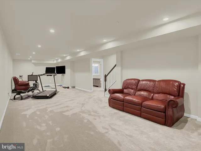 a bedroom with a bed and a flat tv screen on the dresser