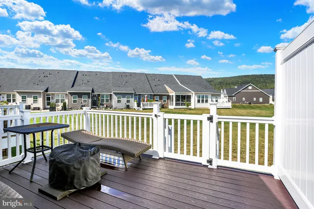 a view of a house with a backyard and deck