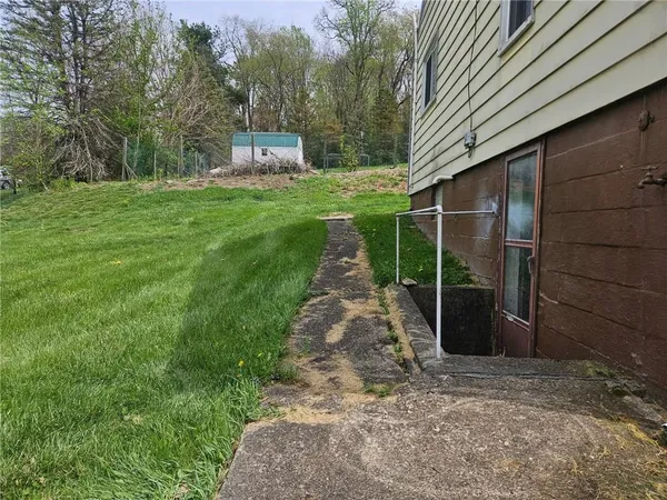 a pathway of a house with backyard