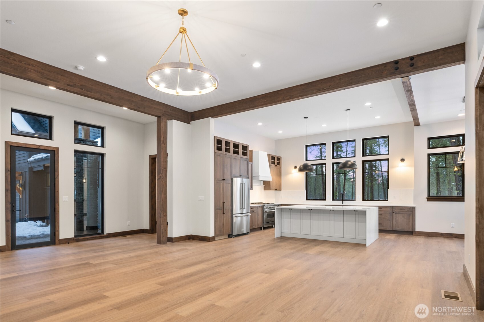 581 Wanawish Loop Cle Elum, WA 98922 - Photo 8 of 40 a view of an empty room with wooden floor and windows
