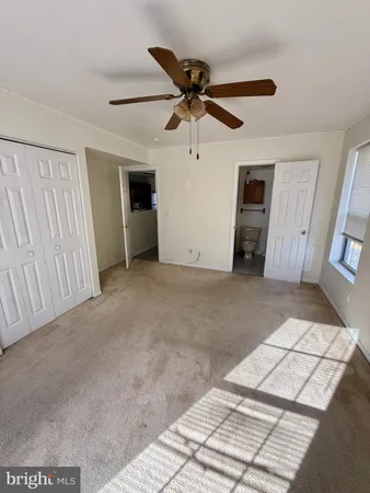 a view of a livingroom with a ceiling fan and window