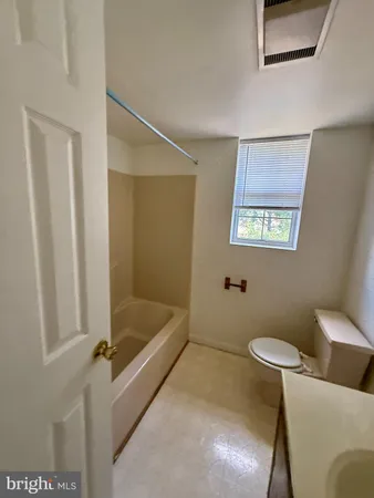 a bathroom with a tub and sink