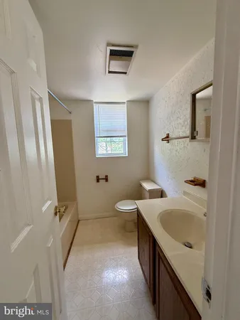 a bathroom with a sink a toilet and mirror