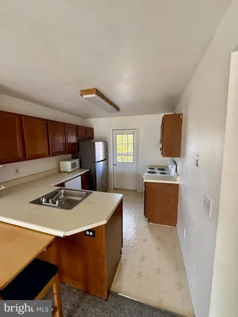 a kitchen with stainless steel appliances a stove a sink dishwasher and a refrigerator