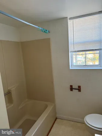 a bathroom with a bathtub and a toilet