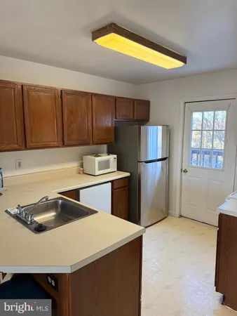 a kitchen with a refrigerator and a sink