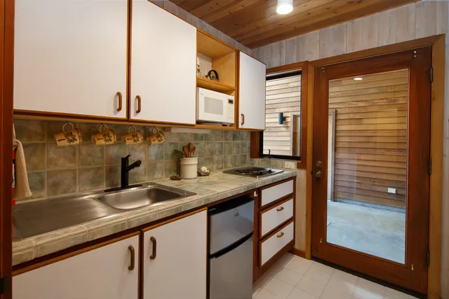 a view of a patio with a table and chairs