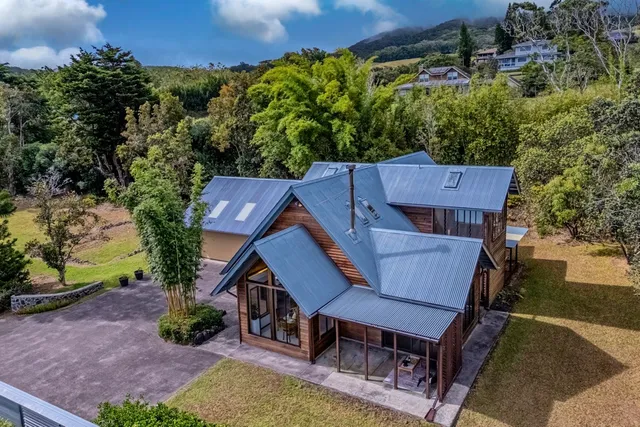 an aerial view of a house with a yard