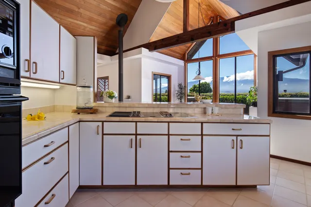a kitchen with cabinets a sink and appliances