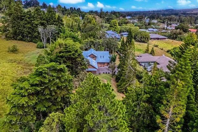 a spacious bedroom with a bed and a chandelier