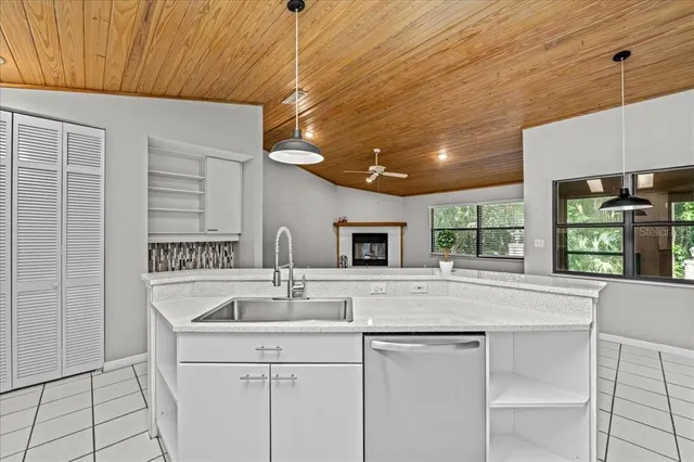 a kitchen with a sink cabinets and window