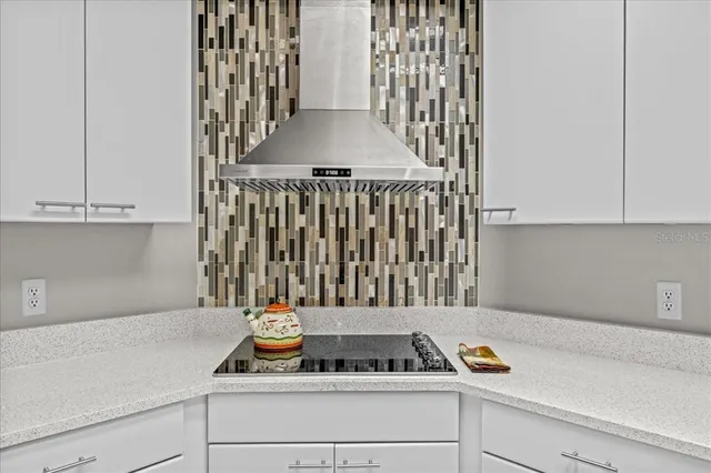 a kitchen with a cabinets a sink and a stove with wooden floor