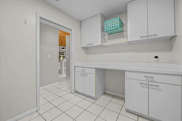 a kitchen with white cabinets and a sink