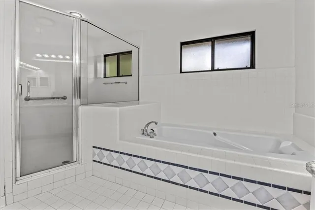 a bathroom with a tub and shower