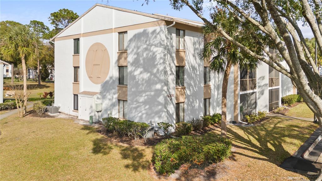 8203 Sun Spring Circle, Unit 12 Orlando, FL 32825 - Photo 1 of 38 a view of a house with a yard